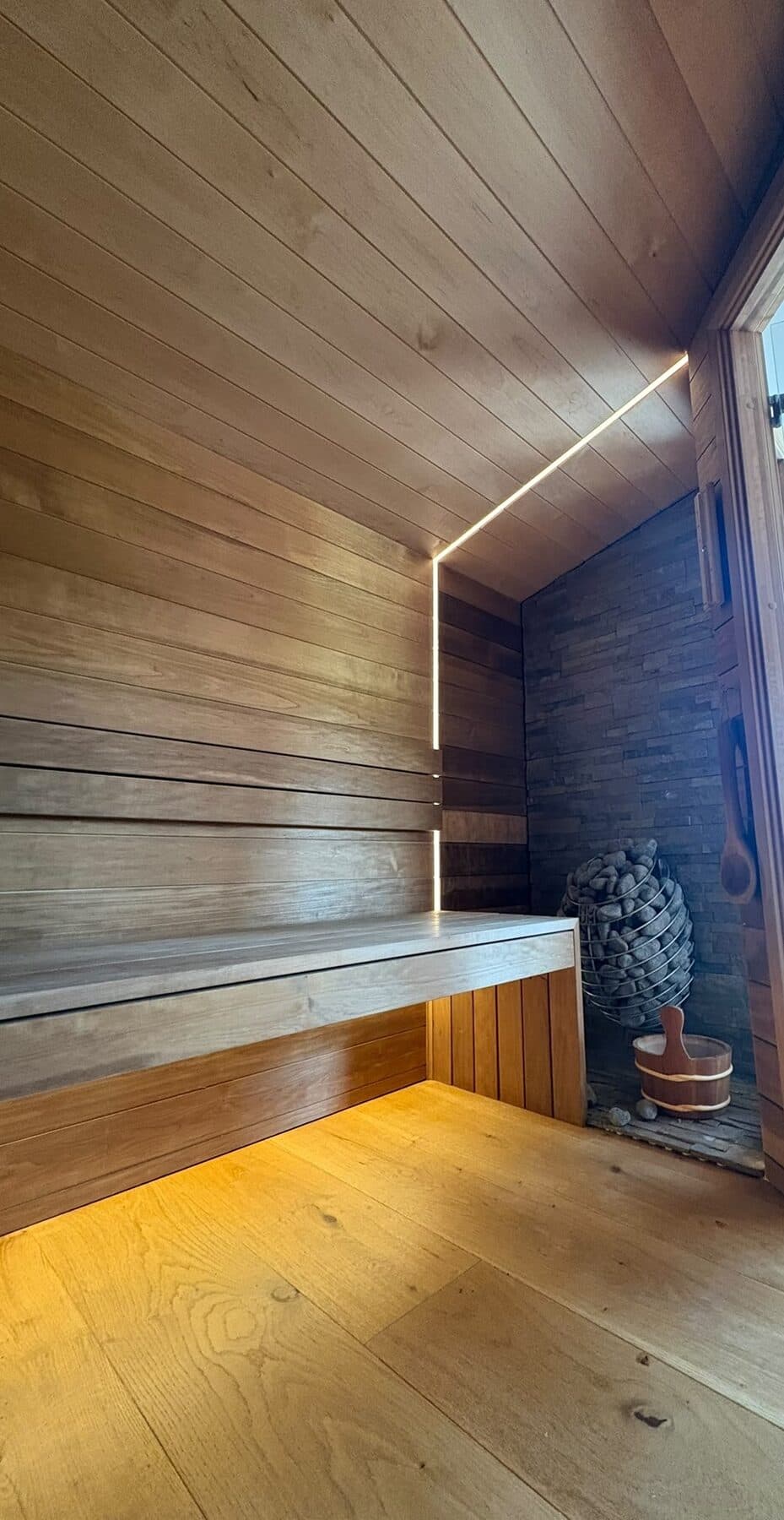 Cedar lined sauna with a concealed LED strip run along the bench and a warm glow under the seating